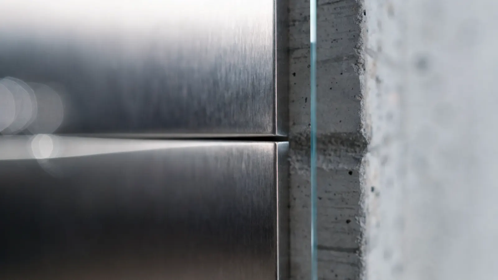 A dimensioned detail drawing overlaid on a photographed edge, illustrating an essay on tolerance and the millimetre.